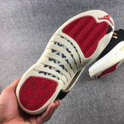 Close-up of the outsole with red herringbone traction sections and light-colored rubber.