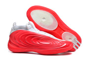Red and white basketball shoes shown from the side and outsole, with concentric traction rings.