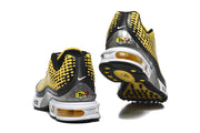 Rear and outsole views of Nike Air Max Plus sneakers in yellow, black, silver, and white.