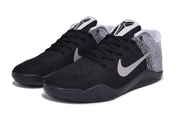 Pair of black and white low-top basketball shoes, front three-quarter view