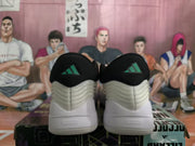 Rear view showing the black heel sections, green Adidas logos, and layered upper detailing.