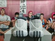 Rear view showing the heel details and grey accents on white Nike GT Cut 3 shoes