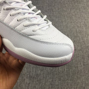 Close-up of the white laces, stitched upper and textured light gray side panel.