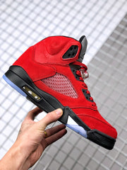 Side profile of the red sneaker highlighting the mesh panel, black midsole, cushioning window, and translucent outsole.
