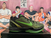 Side view of black and green Nike basketball sneaker with a green Swoosh