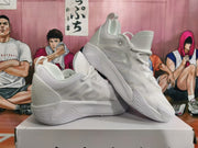 Two white basketball sneakers displayed at an angle, showing their side panels and ridged soles