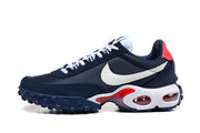 Side view of navy Nike Air Max Waffle SP sneakers with white Swooshes, red accents, and visible cushioning windows.