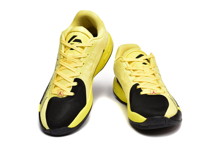 Pair of yellow and black basketball sneakers shown from the front, with black toe panels and lace-up closures.