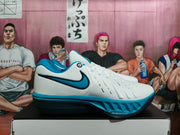 Side view of white Nike LeBron basketball shoes with black and blue accents