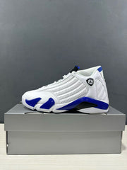 Side profile of one white and blue Jordan Air Jordan 14 sneaker on a gray box.