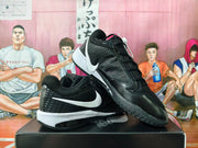 Black and white Nike basketball shoes shown from side and outsole angles