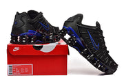 Nike Shox TL sneakers displayed on a red Nike shoe box; the label shows a sample size and style code.