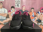 Pair of black and pink low-top basketball sneakers shown from the front