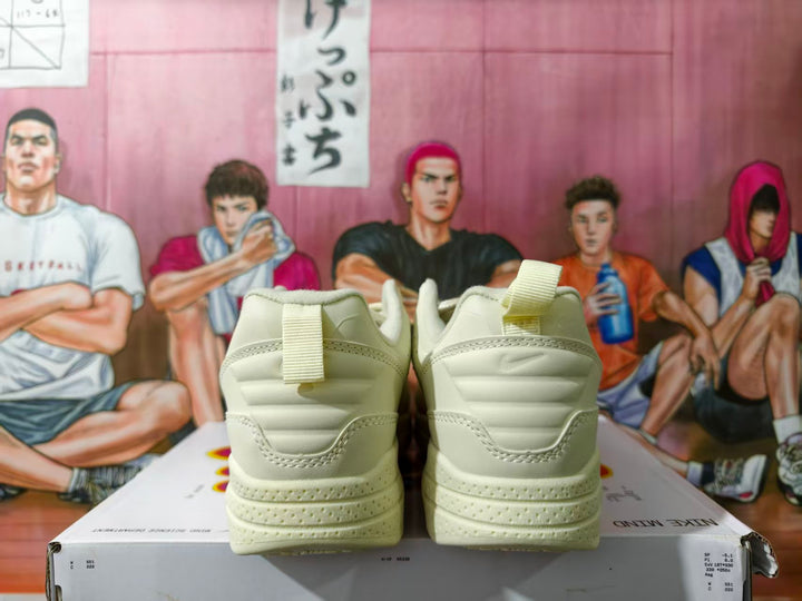 Rear view of beige Nike low-top sneakers on a shoebox