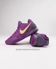 Purple Nike Ja 1 basketball shoes with yellow Swooshes and dark speckled accents