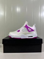 Side profile of a white and Hyper Violet Air Jordan 4 Retro sneaker on a black shoebox.