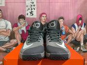 Front view of a pair of grey Nike KD basketball shoes with white Swoosh details