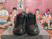 Front view showing the black uppers, royal blue accents, laces, and Jumpman logos.