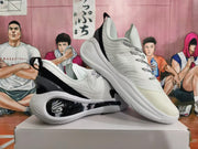 White and black basketball shoes arranged to show their side profile and sole.