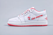 Side profile showing the low-top silhouette, white upper, patterned swoosh, and red outsole.