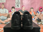 Rear view of black basketball shoes showing the heel panels and soles