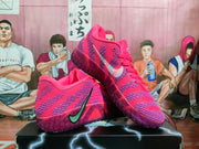 Angled view showing a pair of pink and purple Nike basketball sneakers with lace-up fronts and patterned uppers.