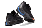 Rear and outsole view of black Nike S.T. Flare EP basketball shoes with blue and orange accents.