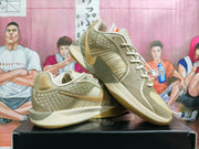 Angled view of the olive and cream basketball shoes