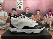 Side profile showing the white upper, glossy black overlays, black outsole, cushioned-looking sole, and the word “Flight” on the side panel.
