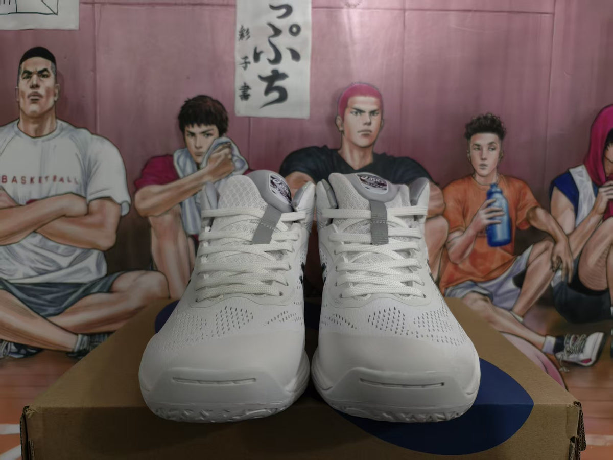 Front view of a pair of white ASICS basketball sneakers with dark blue accents and lace-up closures.