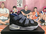 Side profile of a black and purple Nike basketball shoe with multiple straps, a white Swoosh, and a light-colored midsole.
