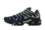 Side view of navy Nike Air Max Plus sneaker with silver and lime-green detailing.