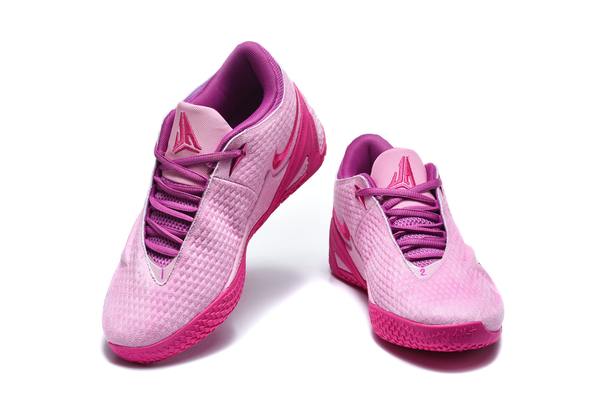Pair of pink and magenta low-top basketball shoes shown from the front