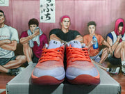 Front view showing coral laces and lavender toe panels on the sneakers.