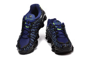 Front and top views of Nike Shox TL sneakers in blue, black, and lime green.