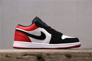 Side profile of a black, white, and red Air Jordan 1 Low sneaker.
