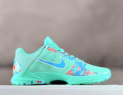 Side profile showing the turquoise upper, blue Swoosh, perforations, and multicolor graphics.
