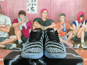 Front view of black and gray Nike basketball shoes with patterned uppers and black laces