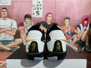 Rear view showing perforated heel panels, black-and-gold detailing, and branded heel tabs.