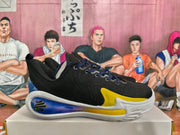 Side view of a black basketball sneaker with blue and yellow cushioning-style accents and a white outsole.