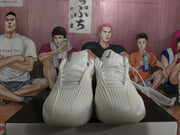 Front view of the white Nike sneakers showing the ridged upper, laces and black Swoosh details.