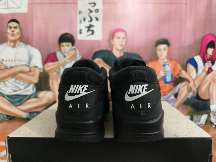 Rear view of black Nike sneakers showing contrasting Nike and AIR heel lettering.