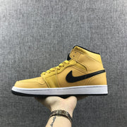 Full side view of the yellow mid-top sneaker with black Swoosh and layered panels.