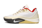 Side view of off-white Nike S.T. Flare EP basketball shoes with red lining and gold-tone details.