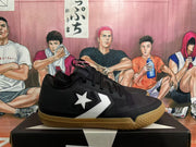 Side view showing the white star-and-chevron emblem on black sneakers