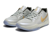 Pair of light gray Nike Ja 2 basketball shoes with gold side logos
