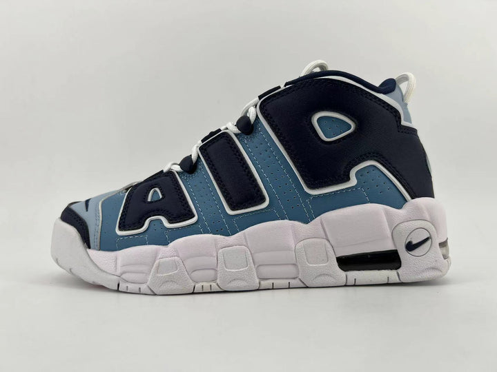 Side view of blue, black, and white Nike Air More Uptempo sneakers with oversized lettering and a chunky white sole