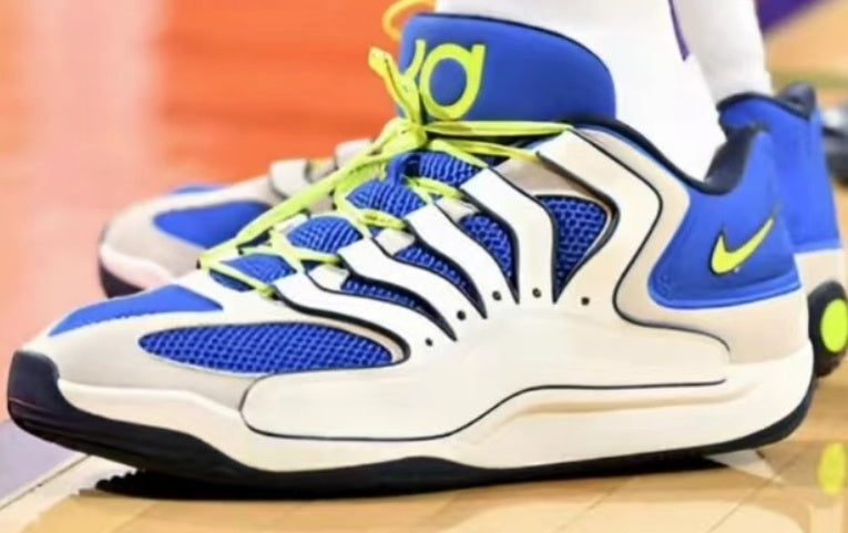 Pair of Nike sneakers in white and blue with neon yellow laces and accents, black outsole, mesh panels, and layered side detailing.