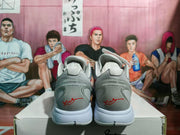 Rear view of the grey and red Nike sneakers showing padded collars, heel detailing, and white midsoles.