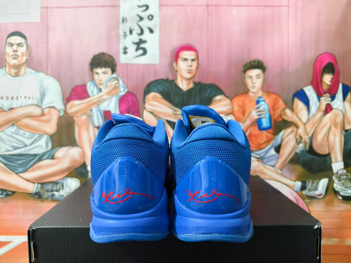 Rear view of blue Nike Kobe basketball shoes showing red heel signatures